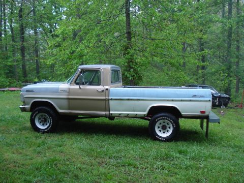 1967 Ford F-250 - This 1967 Ford F-250 pickup truck features a distinctive tan and blue two-tone paint scheme and is shown from the side.