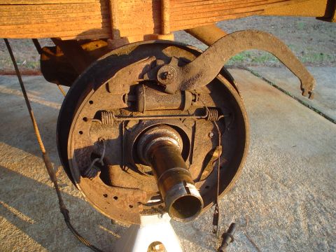1967 Ford F-250 - The rear axle brake assembly is shown disassembled, with the drum removed to expose the internal components.