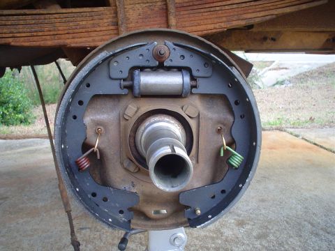 1967 Ford F-250 - The inner workings of a drum brake system, showing the brake shoes, wheel cylinder, and springs.