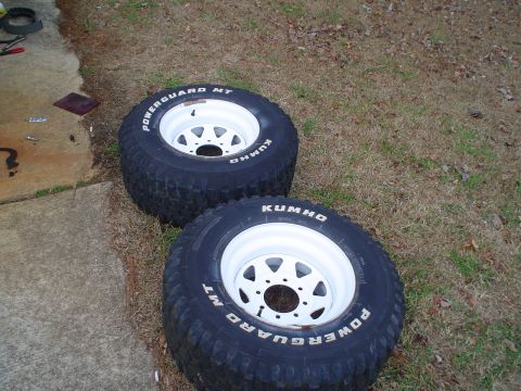 1967 Ford F-250 - Two Kumho Powerguard MT tires on white rims are shown outdoors.