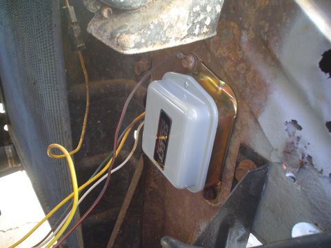 1967 Ford F-250 - A close-up view of an electrical component and wiring, showing signs of rust and wear on the surrounding metal.