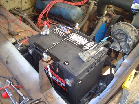 1967 Ford F-250 - Close-up of a Super Start battery and wiring in an engine bay.