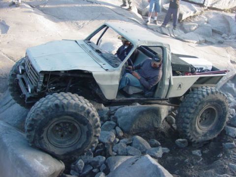 1986 Ford Bronco - This heavily modified truck navigates a rocky terrain during an off-road event.