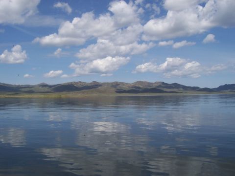 1994 Ford F-150 - Scenic view of a lake with mountains in the background under a cloudy sky.