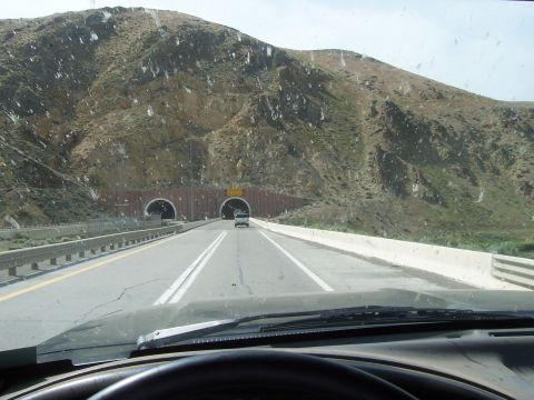 1994 Ford F-150 - The view from the driver's seat shows a highway leading to two tunnels carved into a rocky mountainside.