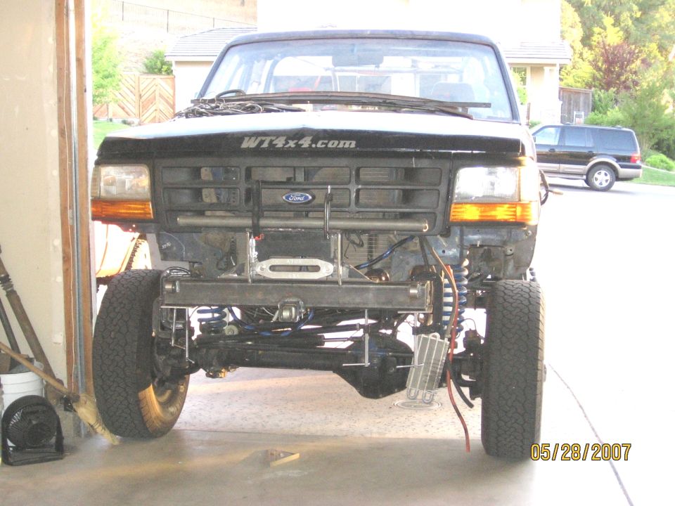 Black Ford Bronco front end with custom bumper and winch, missing grille and headlights