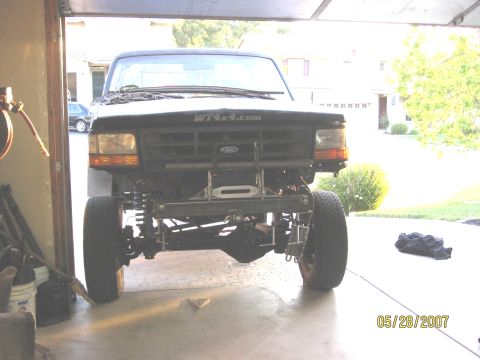 1994 Ford Bronco - Front view of a black Ford truck with a custom bumper and winch installed.