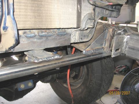 1994 Ford Bronco - Close-up view of a vehicle's modified frame and radiator support, showing extensive welding work.