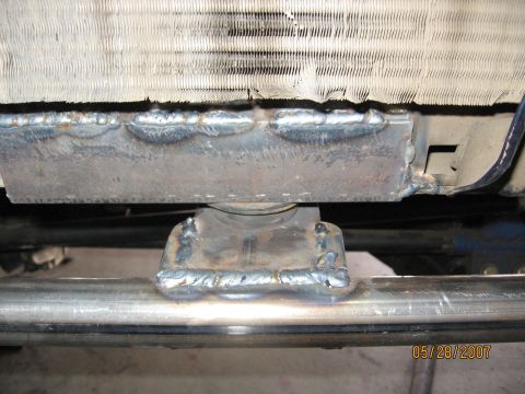 1994 Ford Bronco - Close-up view of a modified radiator support bracket with visible welding.