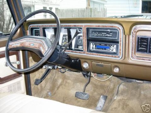 1979 Ford F-150 - The interior of a 1979 Ford F-150 shows its dashboard with woodgrain accents and an updated stereo system.