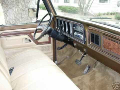1979 Ford F-150 - The interior of this classic truck features wood grain accents and a tan upholstery.