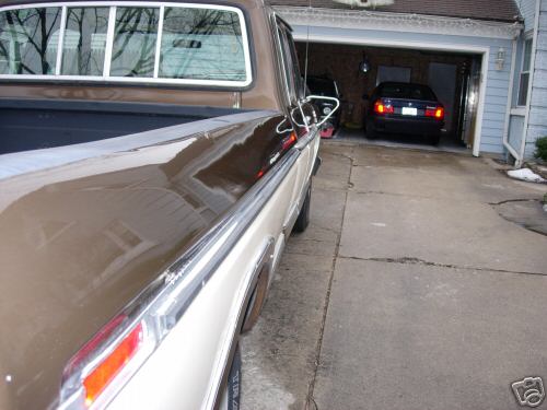 Pickup truck parked in driveway, another car in garage