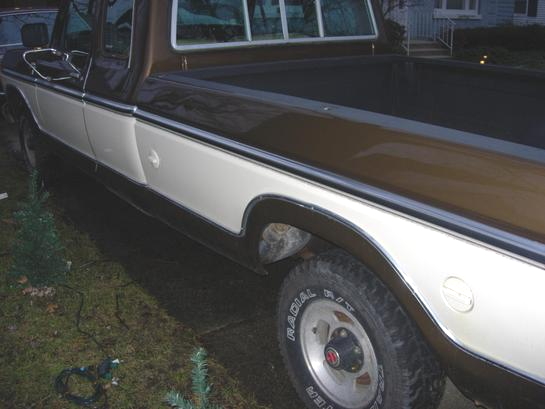 Side view of a 1979 Ford F-150 pickup truck with brown and white paint