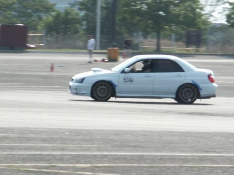 2001 Mercury Grand Marquis - A white sedan with racing number 504 is seen on a track during what appears to be a motorsports event.