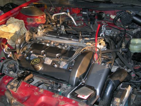 1992 Ford Taurus - Close-up view of a car's engine bay, focusing on the valve covers and surrounding components.