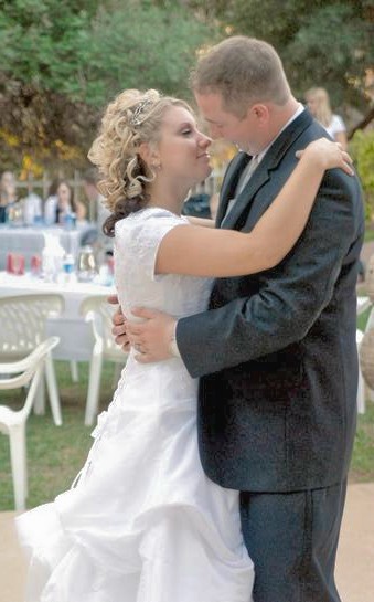 1991 Ford Bronco - A bride and groom share a tender moment during their wedding reception.