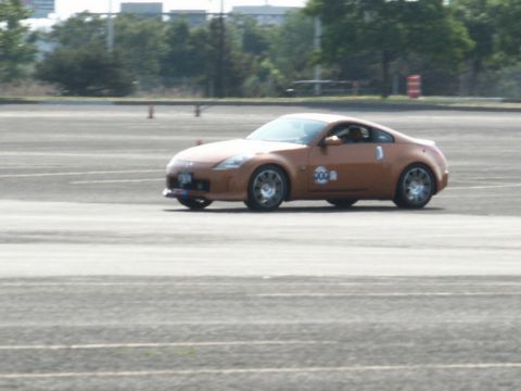 2001 Mercury Grand Marquis - Nissan 350Z seen on an asphalt track during an event.