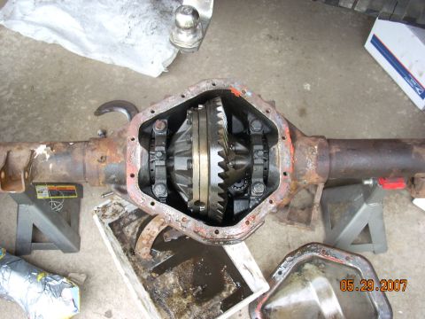 2000 Chevrolet Tahoe - The differential housing, showing internal gears, is supported by jack stands on a concrete surface.