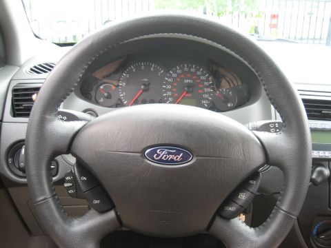 1986 Ford Bronco - The dashboard and steering wheel of a Ford vehicle are shown, with the Ford logo prominently displayed.