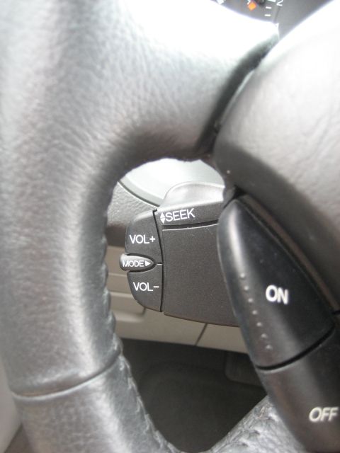 1986 Ford Bronco - Close-up of steering wheel audio controls, indicating a modern vehicle interior.