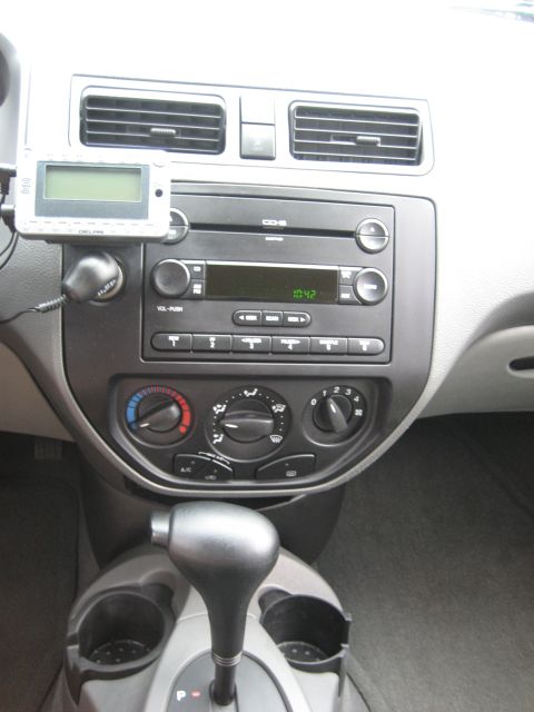 1986 Ford Bronco - The interior dashboard features a GPS unit mounted above the radio and climate controls, with an automatic transmission shifter visible.
