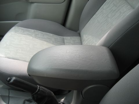 1986 Ford Bronco - Close-up of a car's interior, focusing on the armrest and seat fabric.