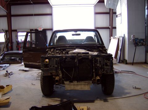 1994 Ford Bronco - This 1994 Ford Bronco is undergoing restoration with its front end removed in a workshop setting.