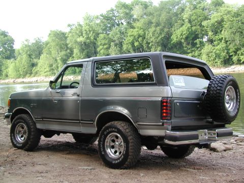 1989 Ford Bronco - This 1989 Ford Bronco is parked on a dirt and gravel area next to a river.