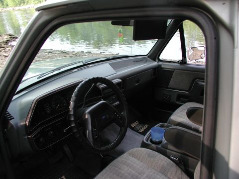 1989 Ford Bronco - Interior view of a 1989 Ford Bronco, the dashboard, steering wheel, and seats.