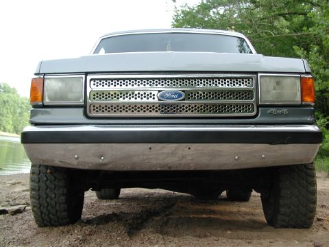 1989 Ford Bronco - Front view of a gray 1987 Ford Bronco, showing its grille and "4x4" badging.