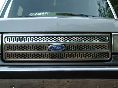 1989 Ford Bronco - Close-up of the 1989 Ford Bronco's distinctive front grille and Ford emblem.