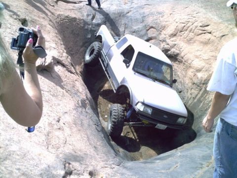 1997 Ford Ranger - White 1997 Ford Ranger is shown off-roading on a challenging rocky terrain.