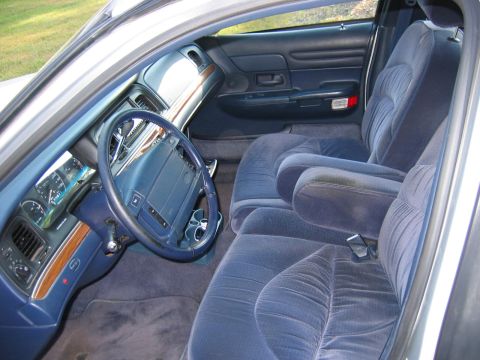 1985 Ford LTD Crown Victoria - Interior view of a 1998 Ford Crown Victoria, highlighting the blue velour upholstery and dashboard details.