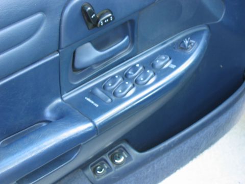 1985 Ford LTD Crown Victoria - Close-up of a car's interior door panel, showing power window and lock controls.