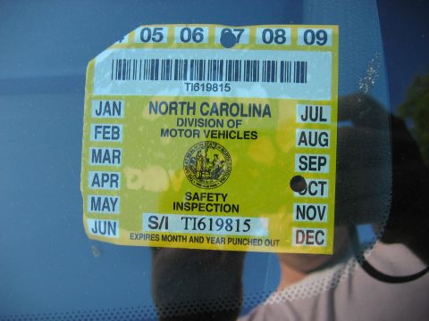 1985 Ford LTD Crown Victoria - North Carolina Division of Motor Vehicles safety inspection windshield sticker with punched expiration year and barcode.