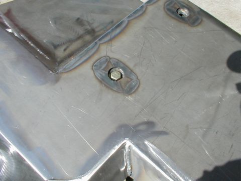 1996 Ford Bronco - Close-up view of a metal skid plate, showing welds and bolt heads.