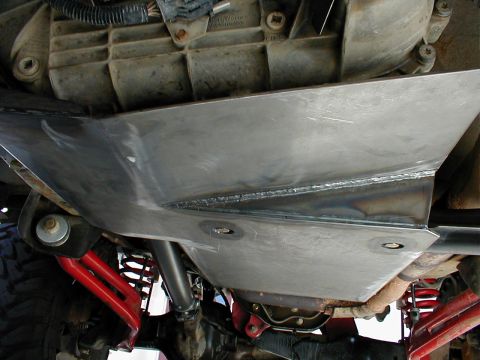 1996 Ford Bronco - Custom skid plate installed under vehicle, showing suspension components and drivetrain parts.