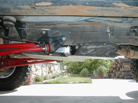 1996 Ford Bronco - Close-up view of the underbody, showing a skid plate and red suspension parts.