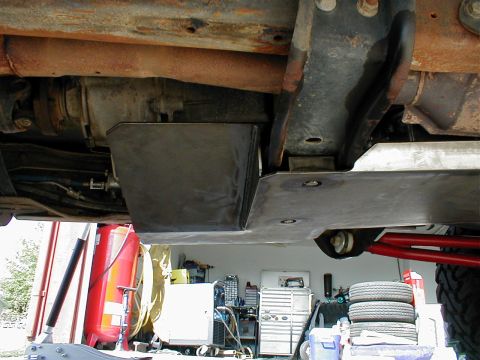 1996 Ford Bronco - Underbody view shows skid plates and drivetrain components, with a garage setting in the background.