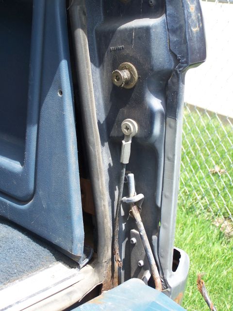 1986 Ford Bronco - Close-up view of the door jamb and latch mechanism of a vehicle.