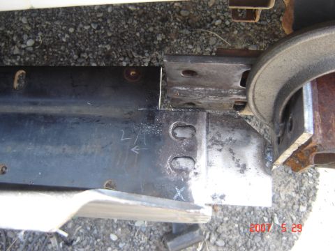 1993 Ford Bronco - Close-up of a metal bracket being worked on, with chalk markings visible.
