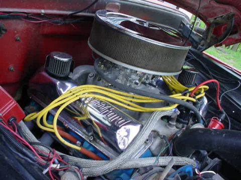 1965 Ford F-100 - Close-up view of the engine compartment of a 1965 Ford F-100, highlighting its V8 engine components.