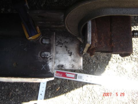 1993 Ford Bronco - A close-up view of a metal bracket being measured, with clamps and welding visible.