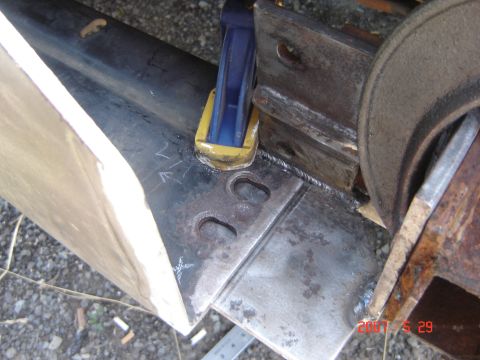 1993 Ford Bronco - Metal parts being welded together with clamps holding them in place during fabrication.