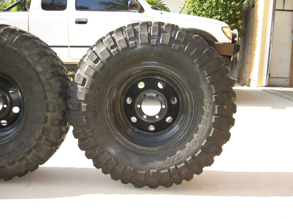 BFGoodrich Krawler T/A KX tires on black steel 6-lug wheels in a driveway