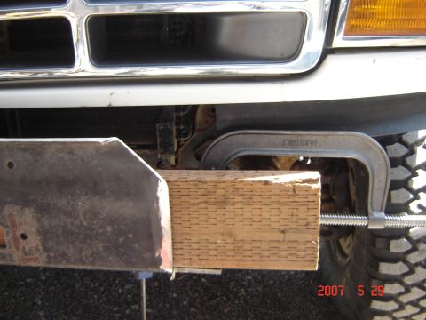1993 Ford Bronco - Front bumper of a 1993 Ford Bronco secured with a C-clamp and a piece of wood.