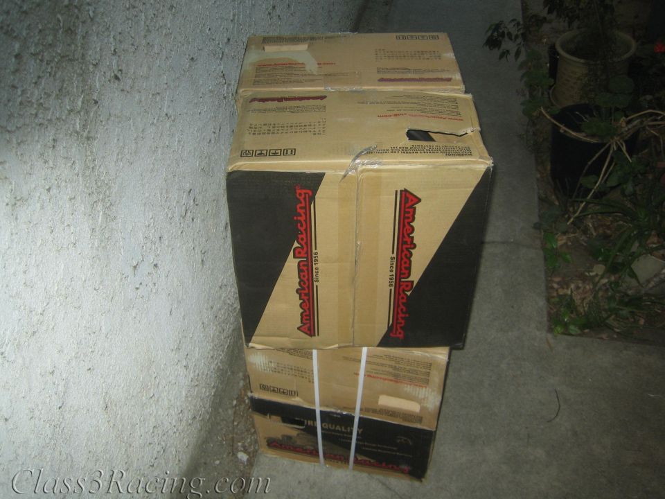 American Racing branded cardboard wheel boxes stacked on concrete