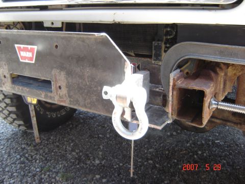 1993 Ford Bronco - Close-up of an aftermarket front bumper with a WARN logo and tow shackle.