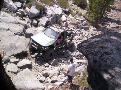 1989 Ford Bronco - Custom off-road vehicle tackling a challenging rocky path.