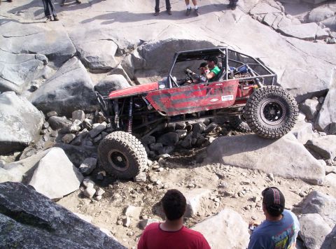 1989 Ford Bronco - A custom rock crawler navigates a challenging boulder-strewn course.